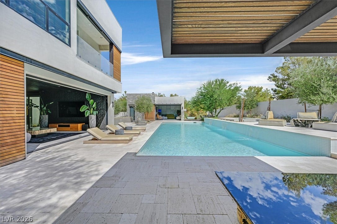 4155 Badura Avenue, Las Vegas, NV 89118 A sleek swimming pool and stone patio anchor this modern outdoor living space.
