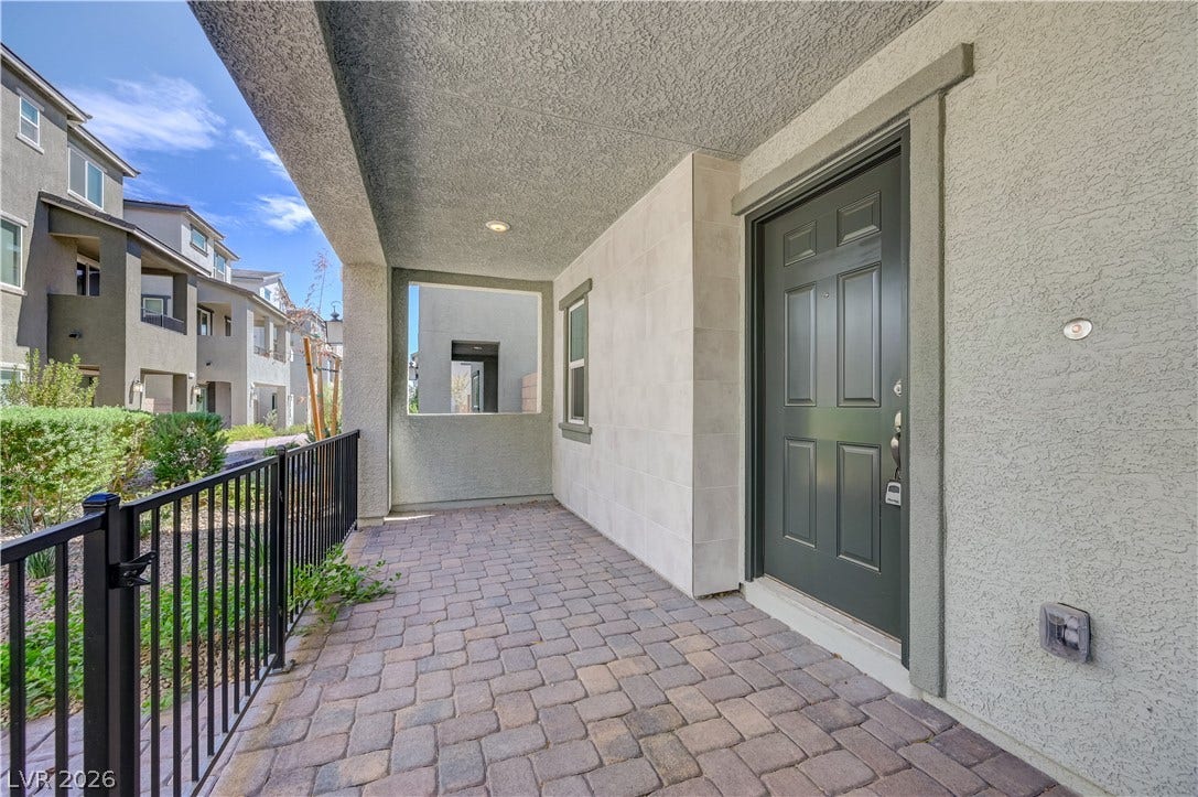 Welcoming covered entry passage paved in neat block stones leads directly to the front entrance.