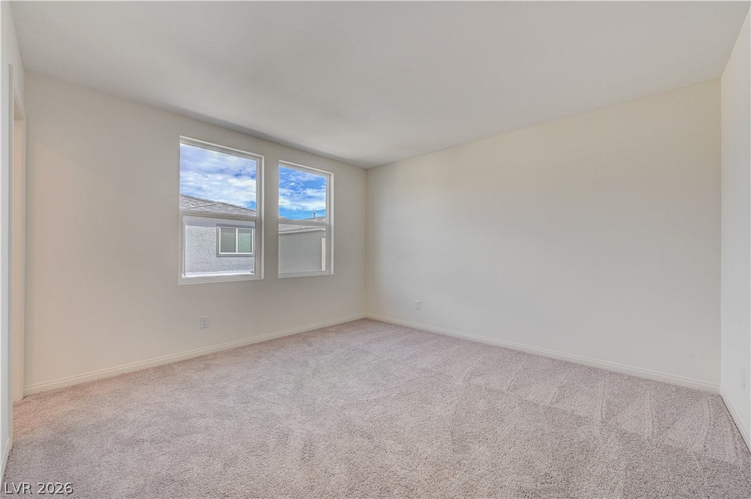 Plush carpeting and dual windows overlooking the neighborhood define this versatile space.