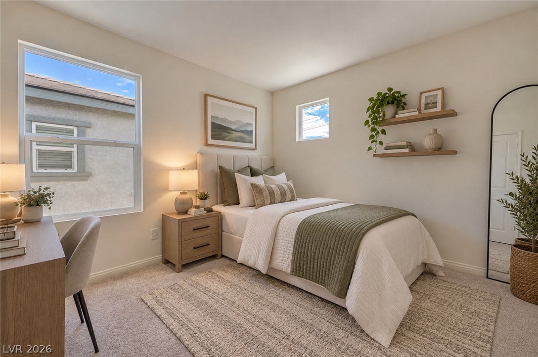 An abundance of natural light illuminates this cozy bedroom featuring soft plush carpeting.