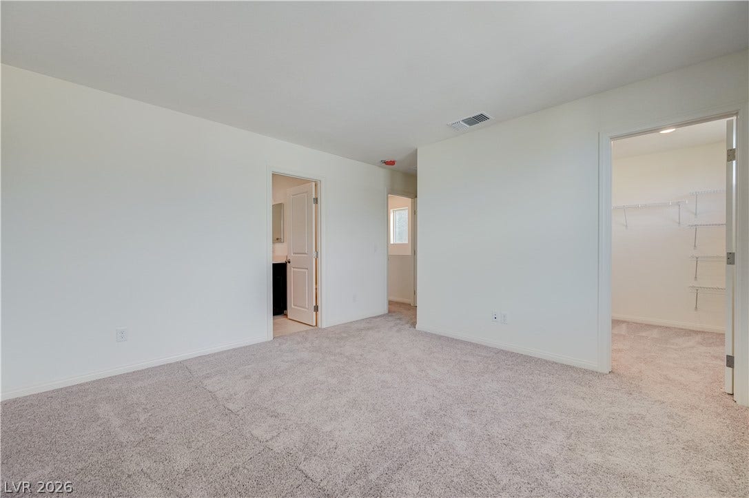 Soft carpeting underfoot defines this comfortable bedroom complete with an attached walk-in closet.