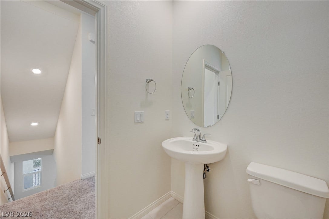 Clean lines and classic fixtures define this minimalist powder room.
