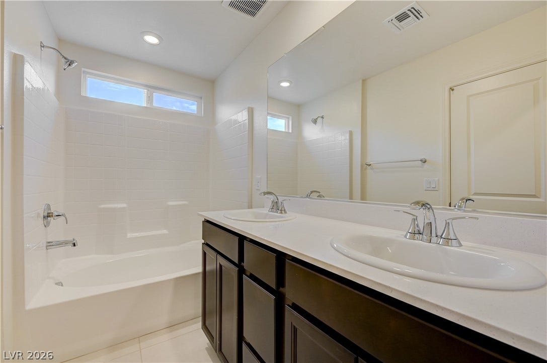 Clean lines and a spacious dual vanity define this modern bathroom.