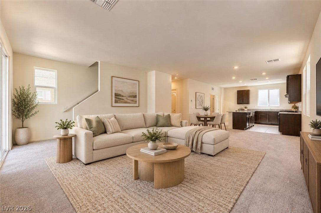 An open floor plan seamlessly connects the living space to the adjacent kitchen.