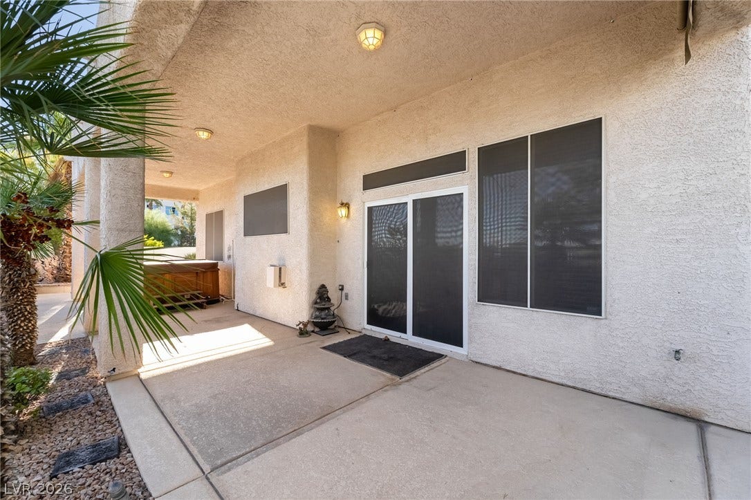 2722 Bass Lake Street, Henderson, NV 89052 Sheltered concrete patio space sits directly adjacent to stucco walls and sliding doors.