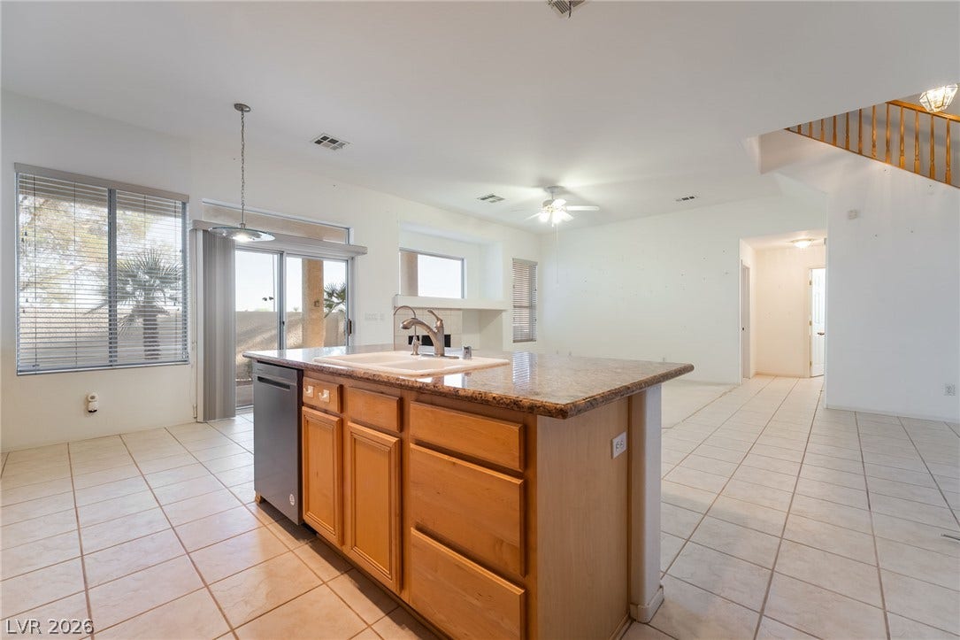 2722 Bass Lake Street, Henderson, NV 89052 Tiled flooring flows through an open-concept layout connecting the kitchen and living areas.