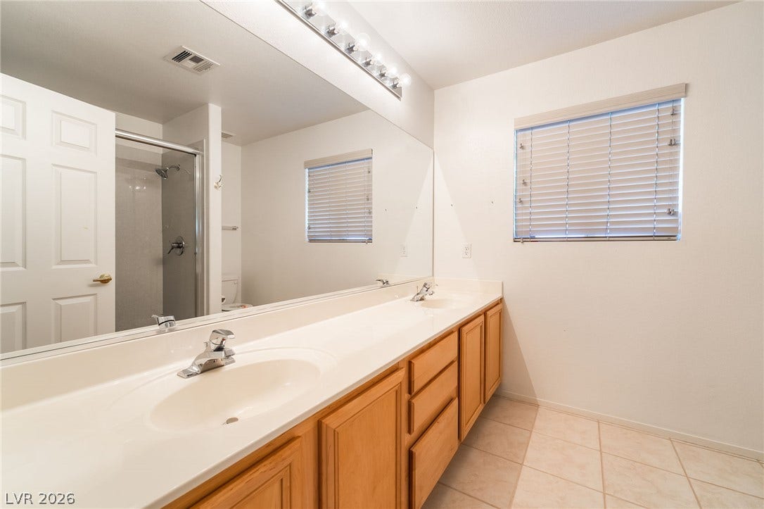 2722 Bass Lake Street, Henderson, NV 89052 A spacious double vanity and tile flooring highlight this classic bathroom design.
