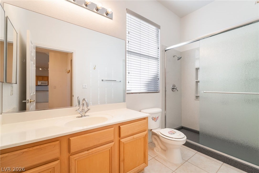2722 Bass Lake Street, Henderson, NV 89052 High ceilings and a glass-enclosed shower highlight this functional, well-lit bathroom space.