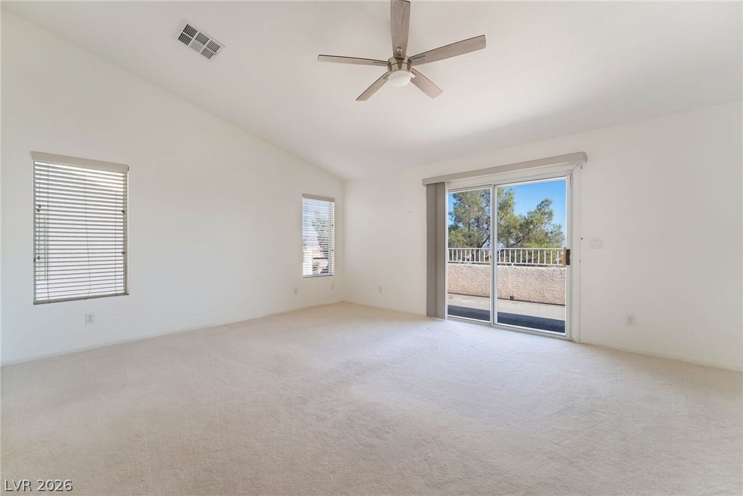 2722 Bass Lake Street, Henderson, NV 89052 Sliding glass doors open to a private balcony in this airy vaulted bedroom.