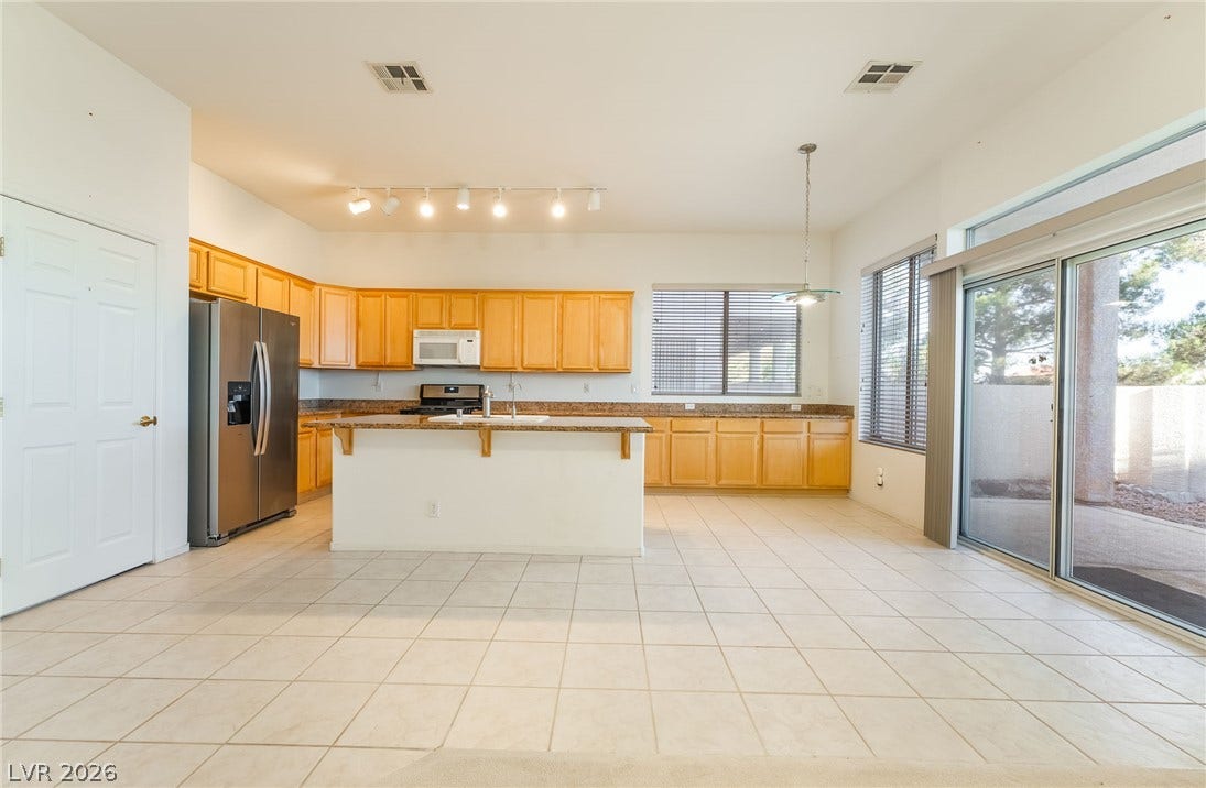 2722 Bass Lake Street, Henderson, NV 89052 Tiled flooring runs throughout this spacious culinary space featuring sliding doors to the patio.