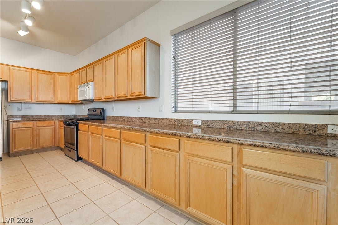 2722 Bass Lake Street, Henderson, NV 89052 Ample counter space and classic wood cabinetry define this functional kitchen layout.