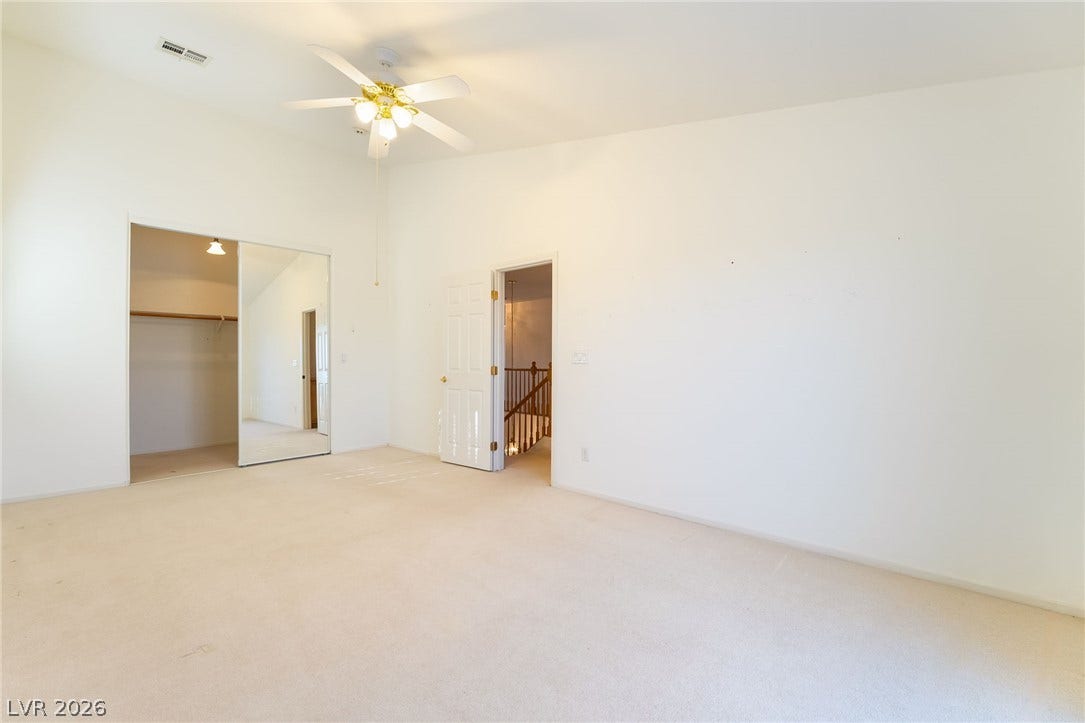 2722 Bass Lake Street, Henderson, NV 89052 A spacious bedroom offers plush carpeting, vaulted ceilings, and a mirrored closet.