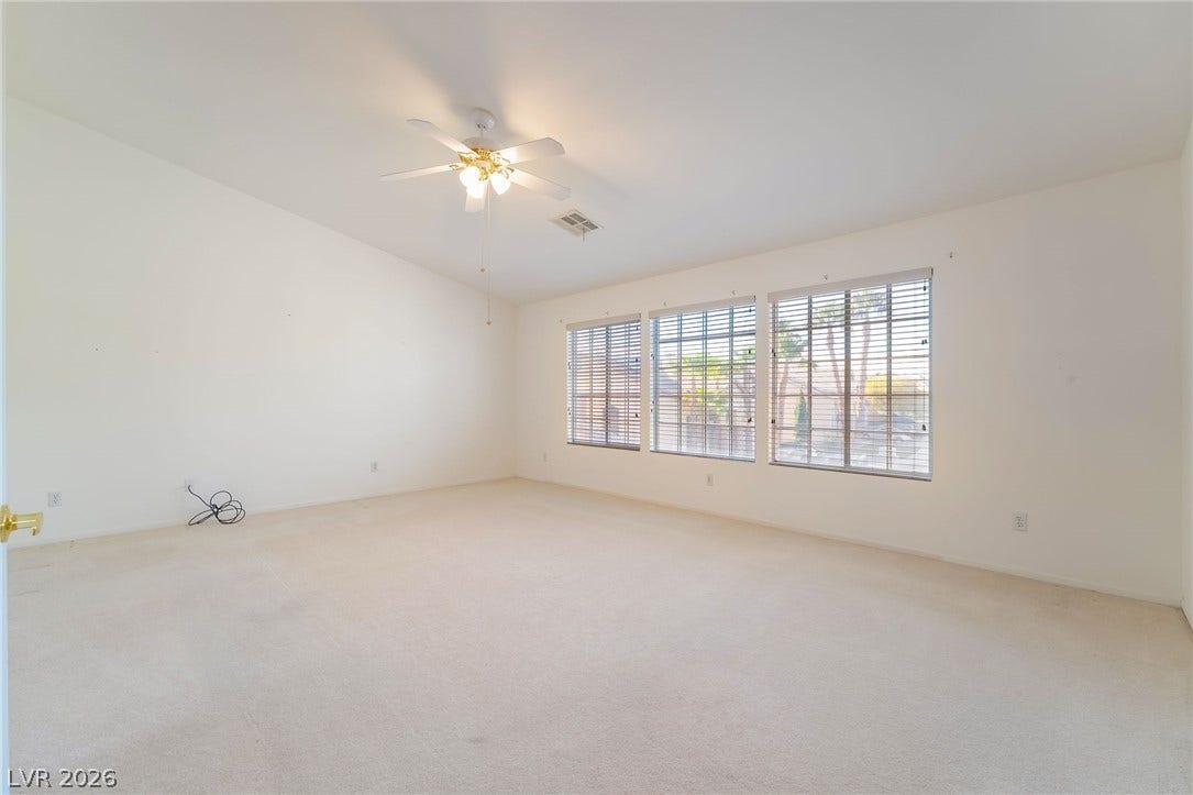 2722 Bass Lake Street, Henderson, NV 89052 Generous windows fill this carpeted living area with abundant natural light.