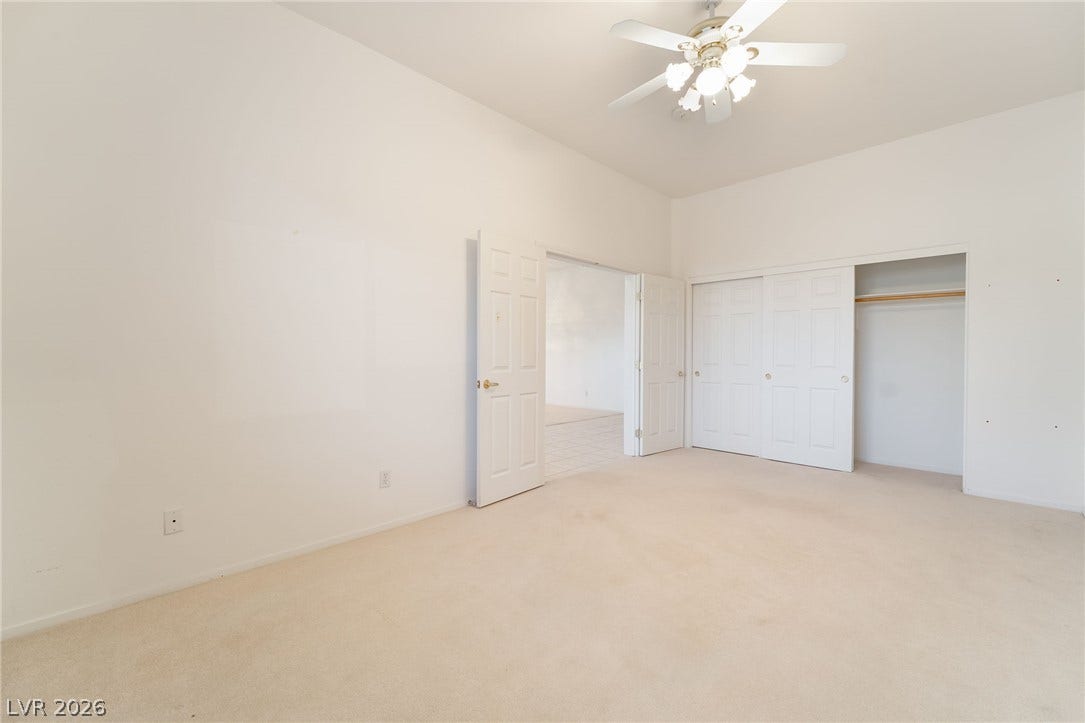2722 Bass Lake Street, Henderson, NV 89052 A spacious bedroom offers neutral carpeting, clean white walls, and a large closet.