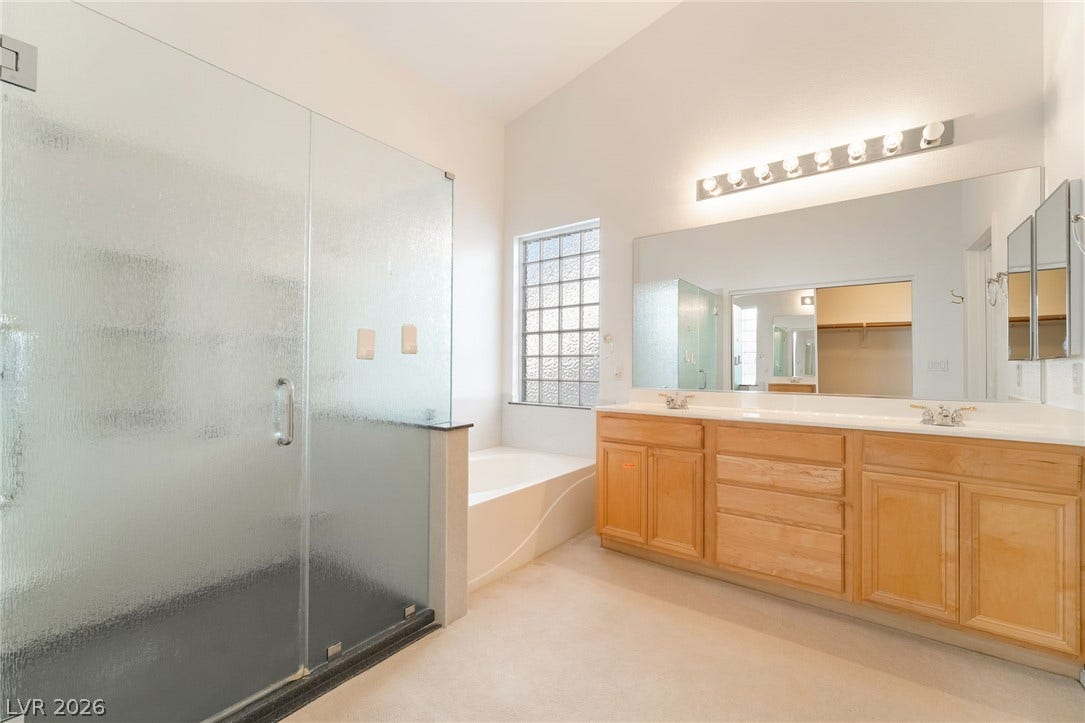 2722 Bass Lake Street, Henderson, NV 89052 High ceilings and a glass-enclosed shower define this spacious bathroom.