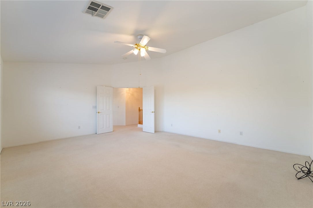 2722 Bass Lake Street, Henderson, NV 89052 Double doors open into a spacious carpeted room with vaulted ceilings.