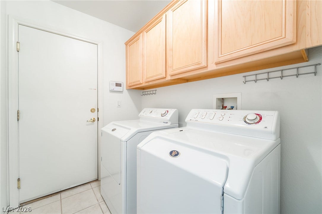 2722 Bass Lake Street, Henderson, NV 89052 Ample wooden cabinetry and tile flooring define this functional home utility space.