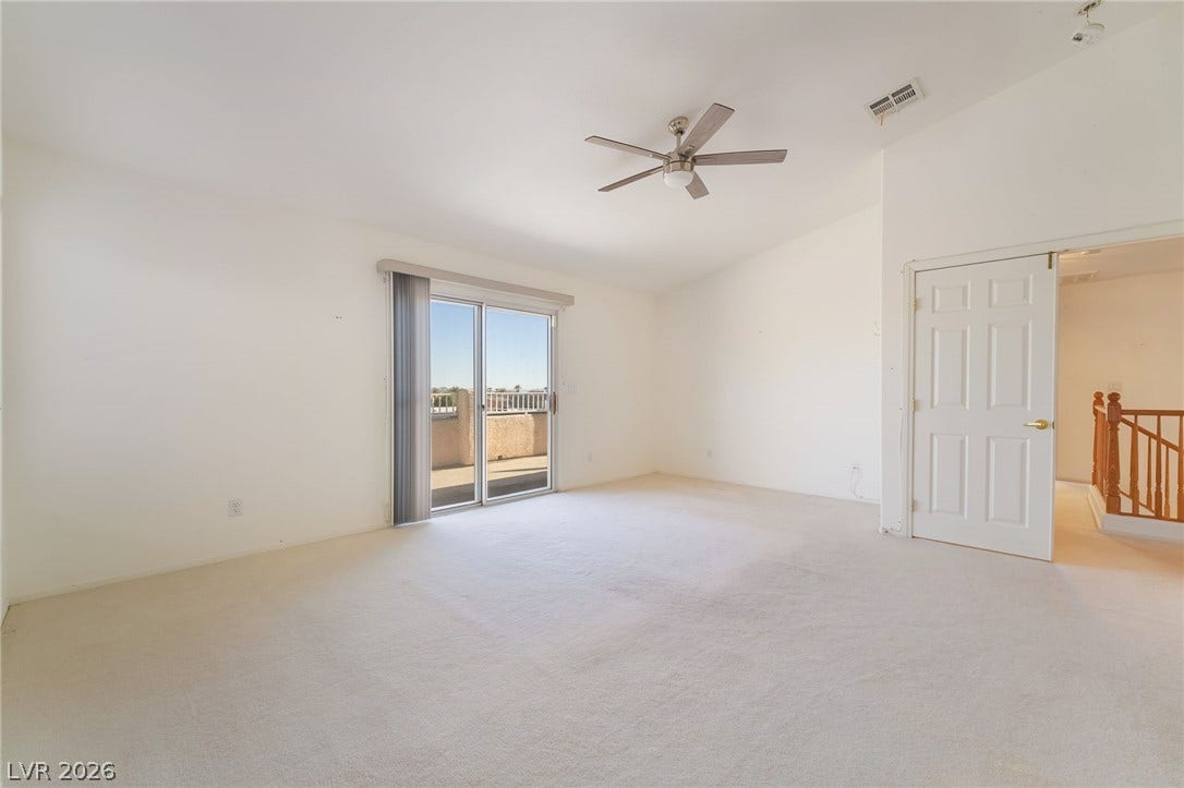 2722 Bass Lake Street, Henderson, NV 89052 Sliding glass doors open to a private balcony from this spacious bedroom.