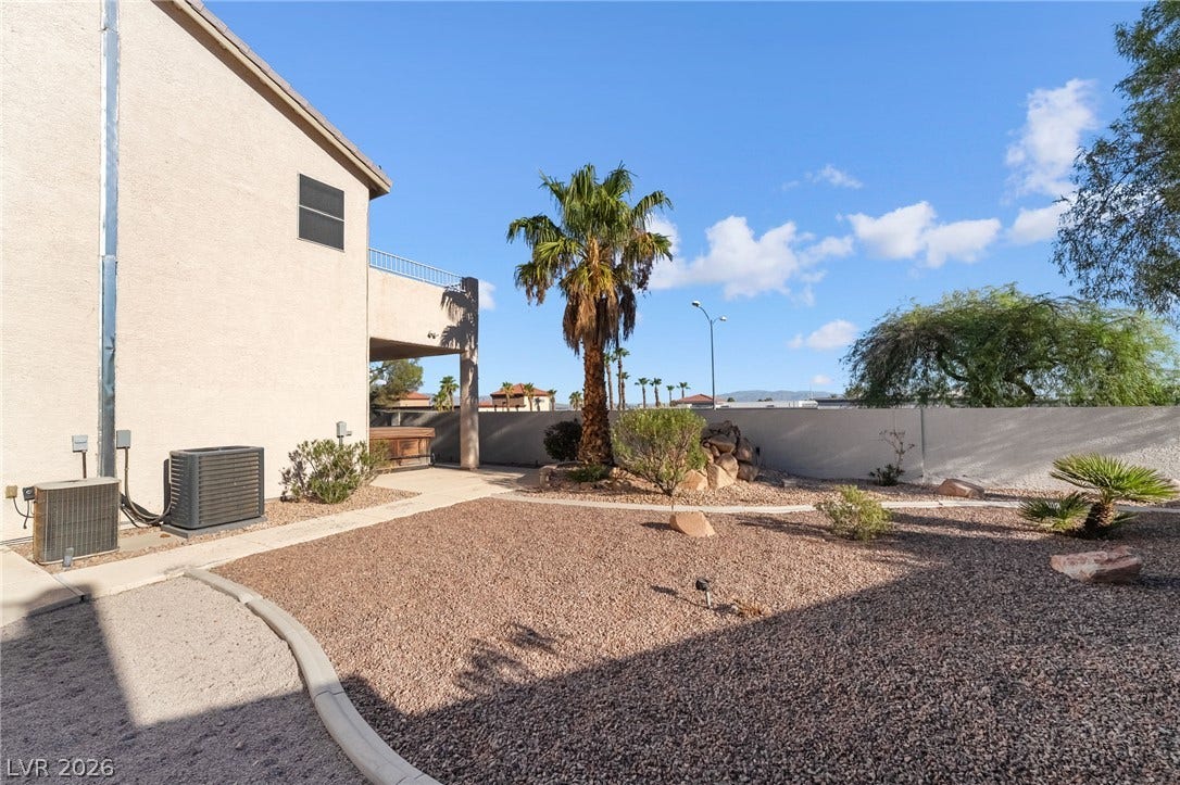 2722 Bass Lake Street, Henderson, NV 89052 Low-maintenance desert landscaping frames the rear yard beneath clear blue skies.