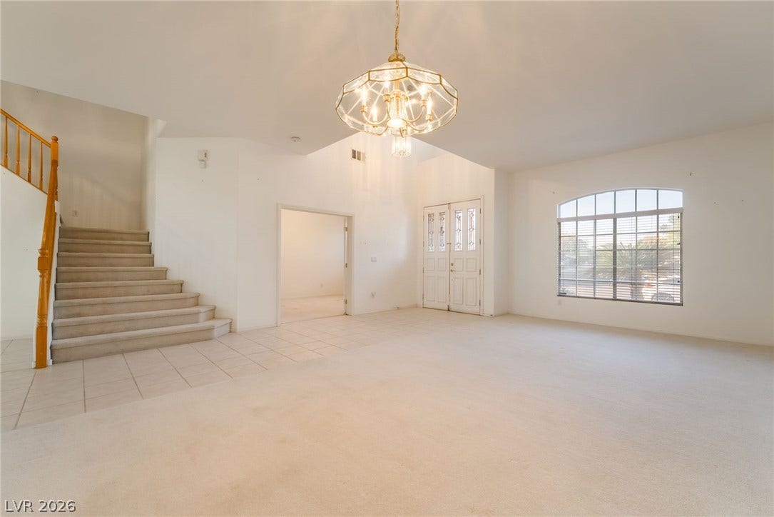 2722 Bass Lake Street, Henderson, NV 89052 An open entryway features vaulted ceilings, tile accents, and carpeted flooring.