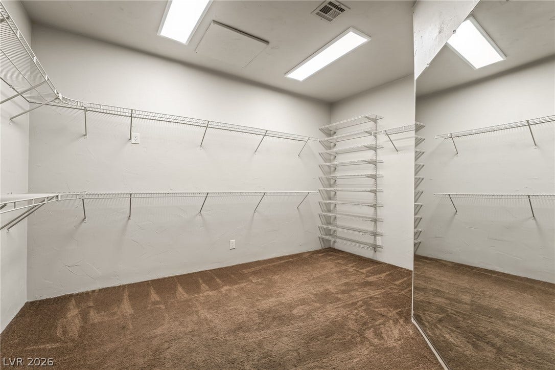 7154 Ranchito Circle, Las Vegas, NV 89120 Ample wire shelving and plush carpeting define this spacious closet featuring a large mirrored wall.