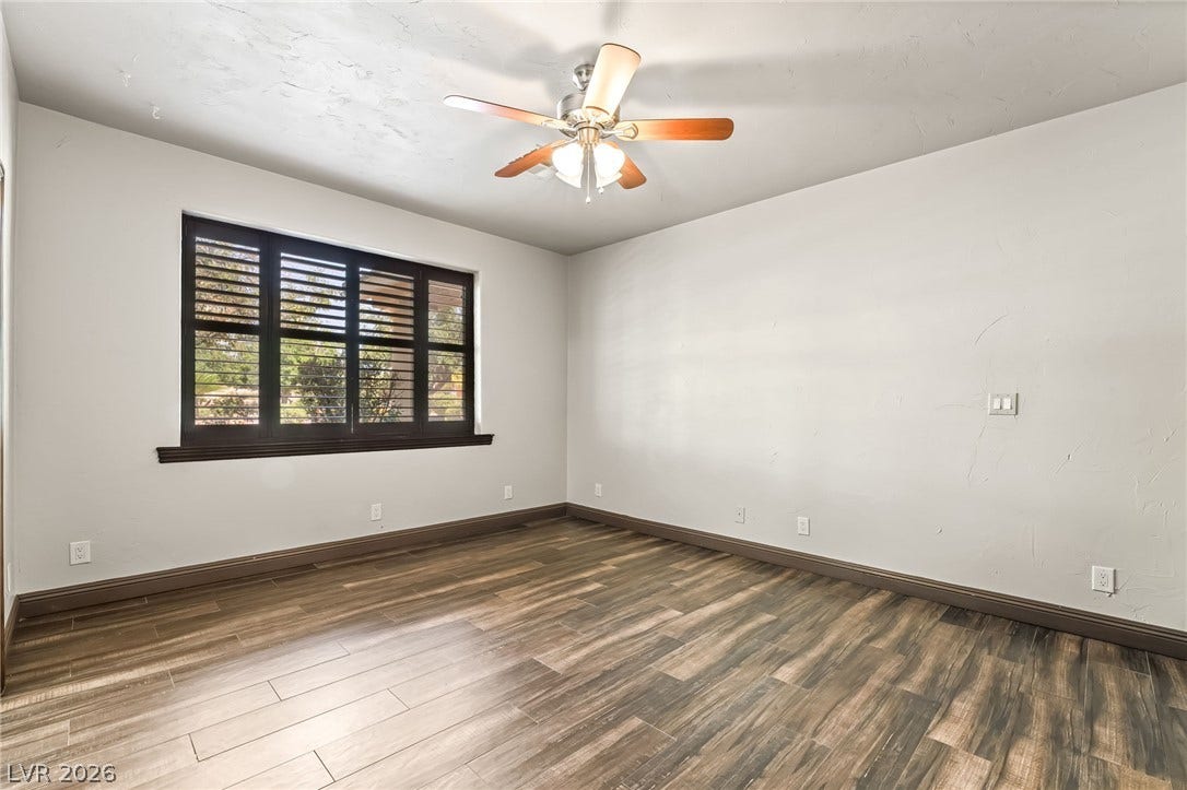 7154 Ranchito Circle, Las Vegas, NV 89120 Rich wood-look flooring and dark window shutters bring classic character to this versatile space.