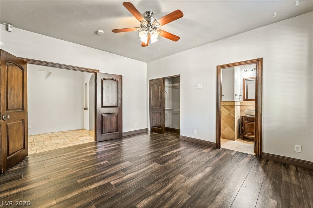 7154 Ranchito Circle, Las Vegas, NV 89120 Gleaming wood-look floors pair beautifully with rich, substantial wood doors in this versatile room.
