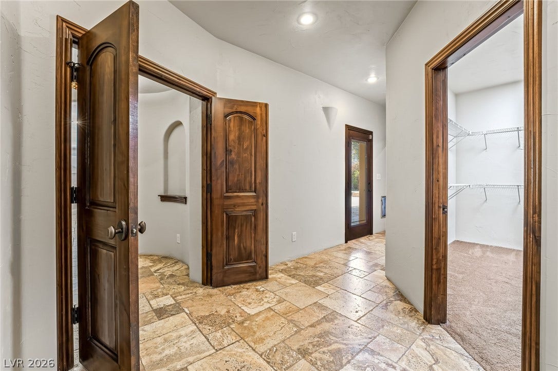 7154 Ranchito Circle, Las Vegas, NV 89120 Rich wood doors and textured tile flooring create an inviting transition between spacious rooms.
