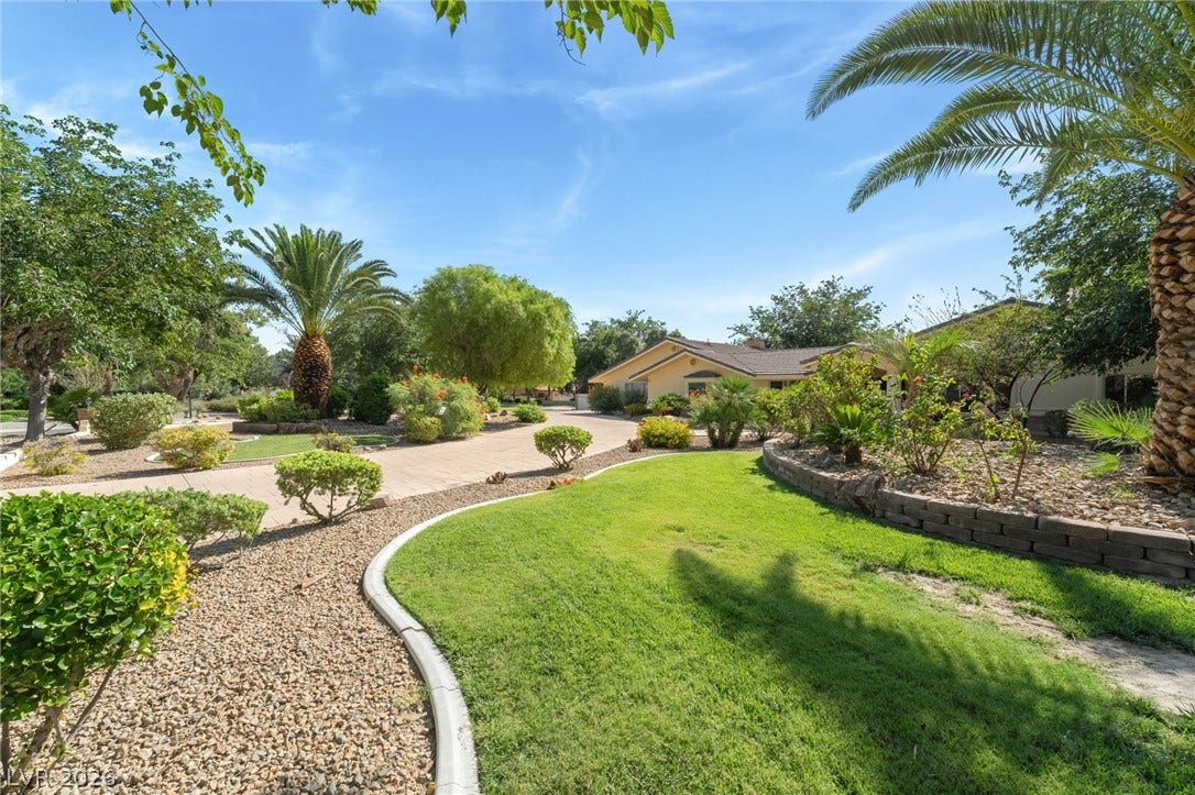 7154 Ranchito Circle, Las Vegas, NV 89120 Manicured lawns and mature palms create a welcoming approach to this classic ranch-style home.