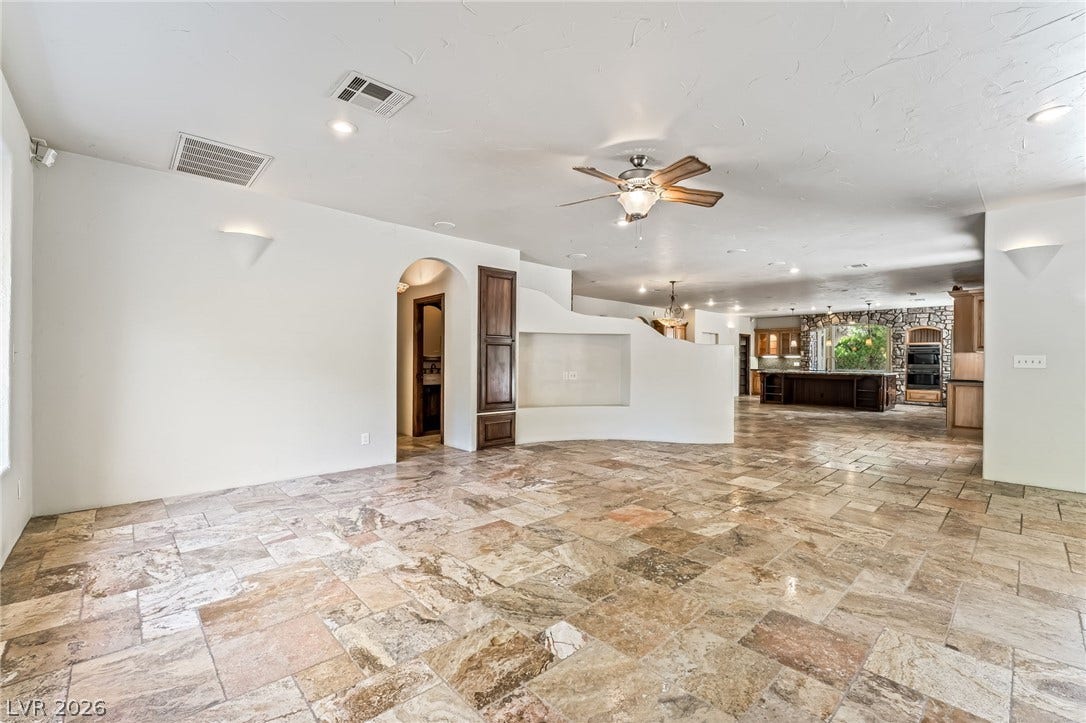 7154 Ranchito Circle, Las Vegas, NV 89120 Natural stone tile floors sweep through this expansive, open layout connecting major living spaces.