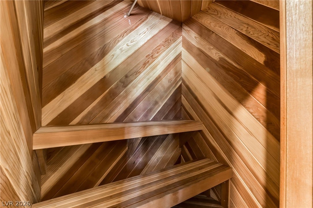 7154 Ranchito Circle, Las Vegas, NV 89120 Rich cedar paneling lines this custom walk-in closet space.