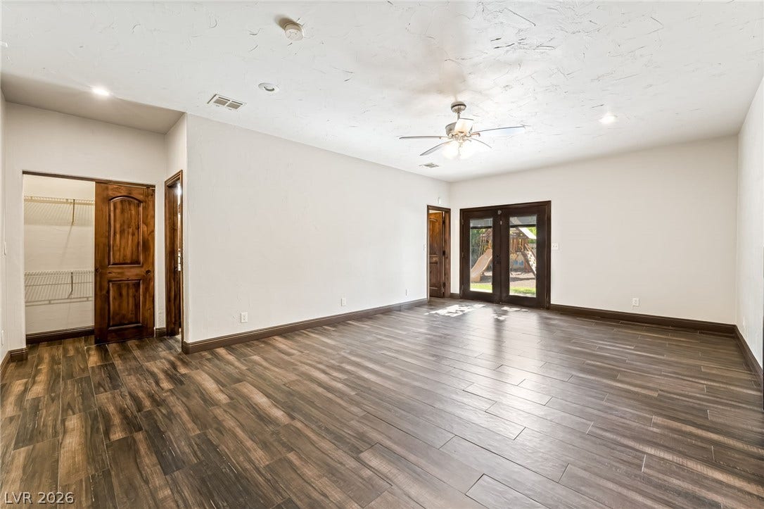 7154 Ranchito Circle, Las Vegas, NV 89120 Rich wood-look tile flooring and French doors define this versatile interior space.