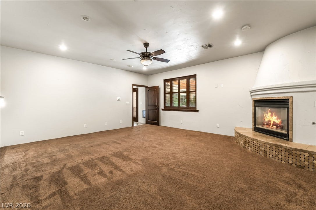 7154 Ranchito Circle, Las Vegas, NV 89120 An inviting corner kiva fireplace anchors this comfortable living space with warm carpeting.