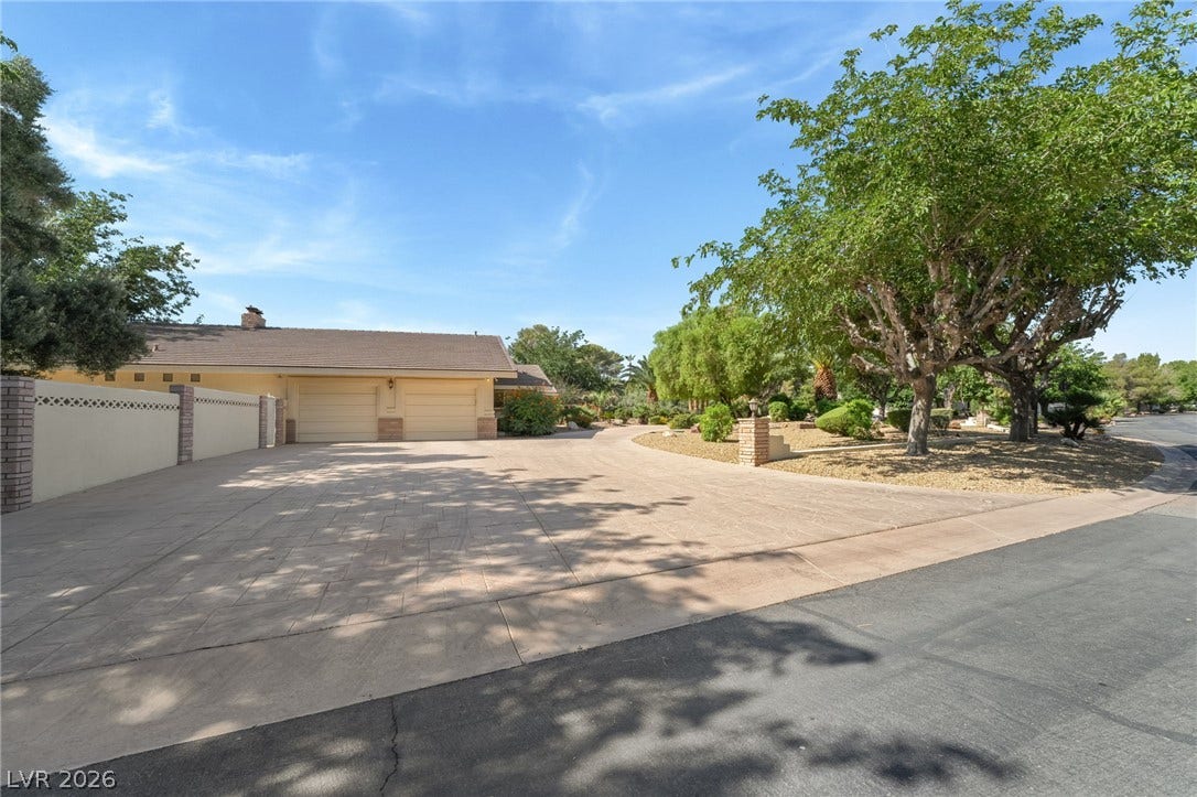 7154 Ranchito Circle, Las Vegas, NV 89120 A spacious stamped concrete driveway leads directly to the attached multi-car garage.