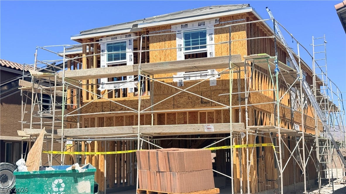 4240 Mount Bonnell Avenue, North Las Vegas, NV 89081 Progress continues on this two-story residential structure featuring wood framing and newly installed windows.