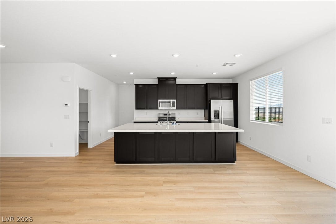 1670 Capri Falls Court, Henderson, NV 89011 Clean lines and a spacious kitchen island define this contemporary open-plan culinary space.