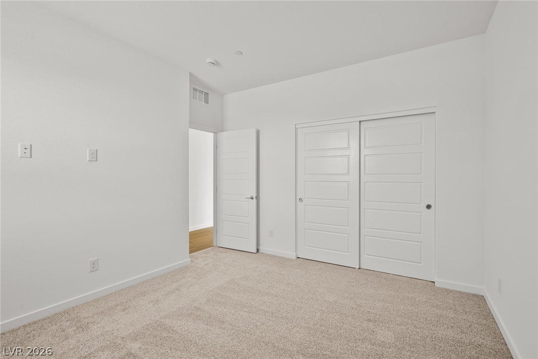 1670 Capri Falls Court, Henderson, NV 89011 Plush carpeting and modern panel doors define this comfortable, neutral bedroom space.
