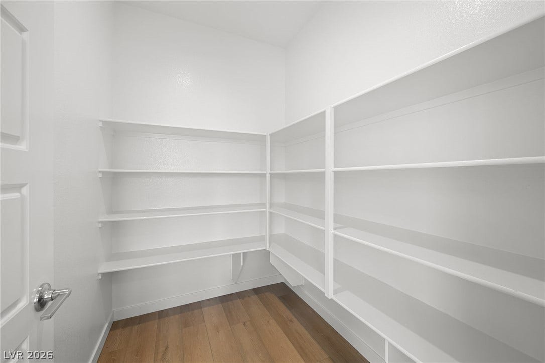 1670 Capri Falls Court, Henderson, NV 89011 Ample built-in shelving and rich wood flooring maximize organization in this functional walk-in pantry.