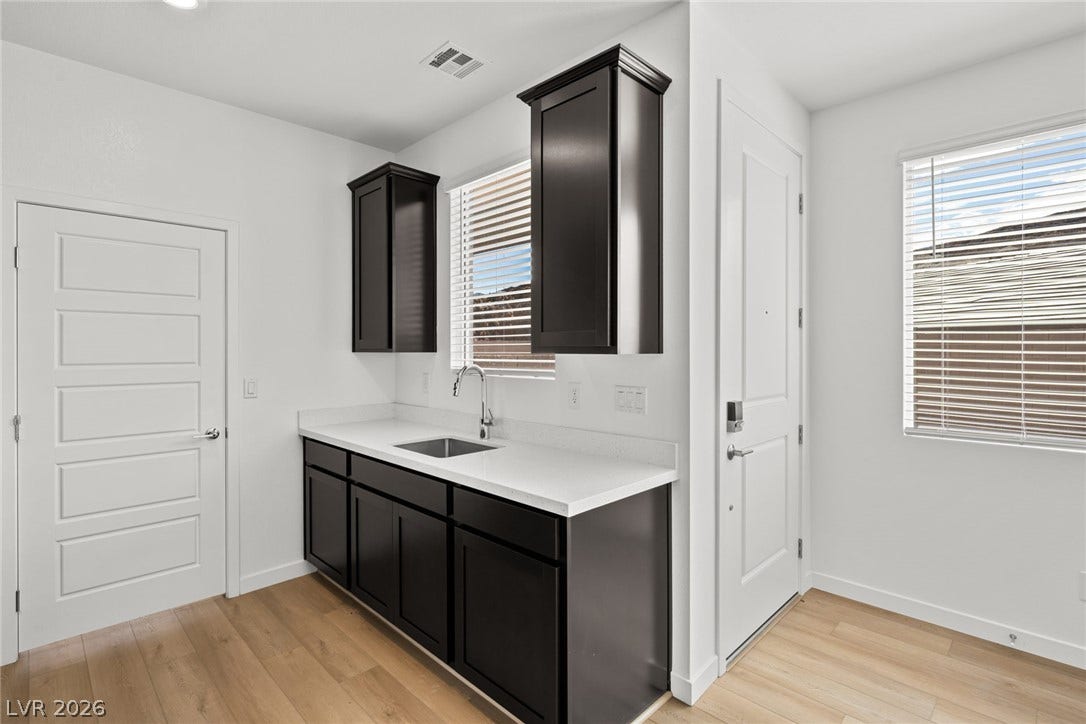 1670 Capri Falls Court, Henderson, NV 89011 Dark cabinetry contrasts beautifully with clean countertops and light-toned flooring.