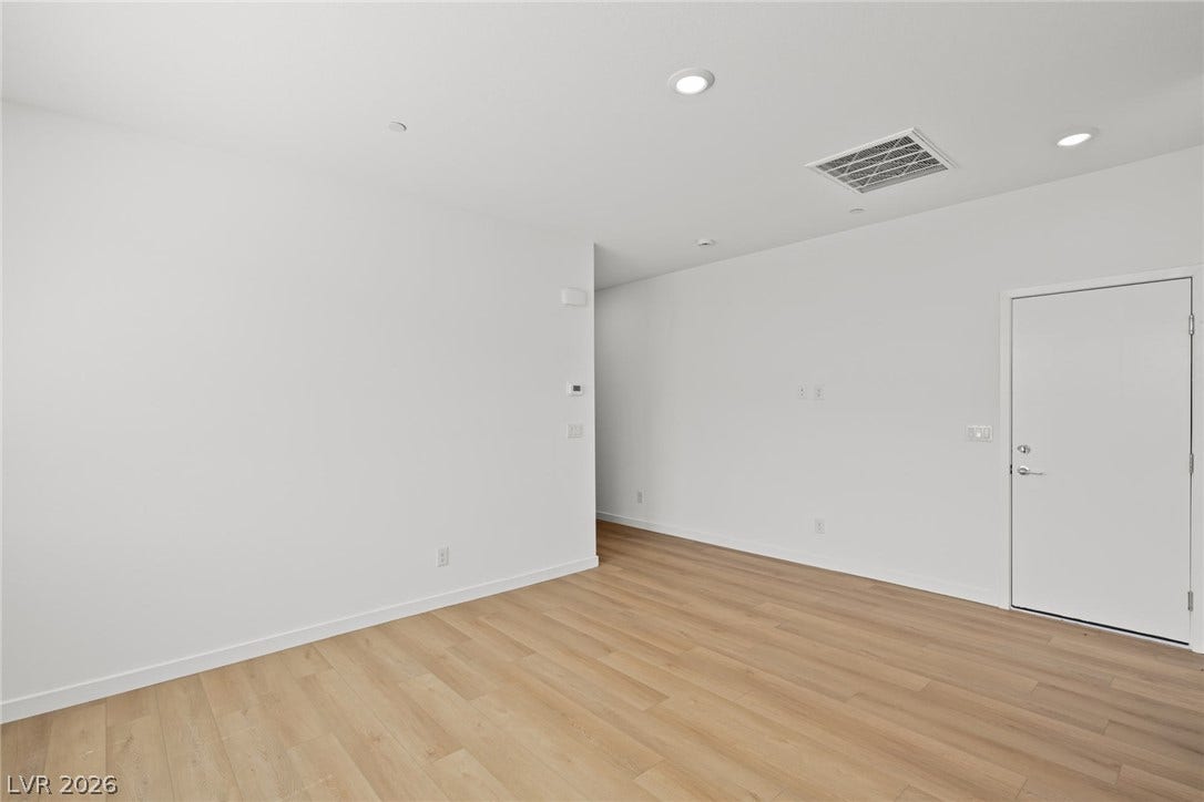 1670 Capri Falls Court, Henderson, NV 89011 An open layout highlights clean white walls and light wood flooring.