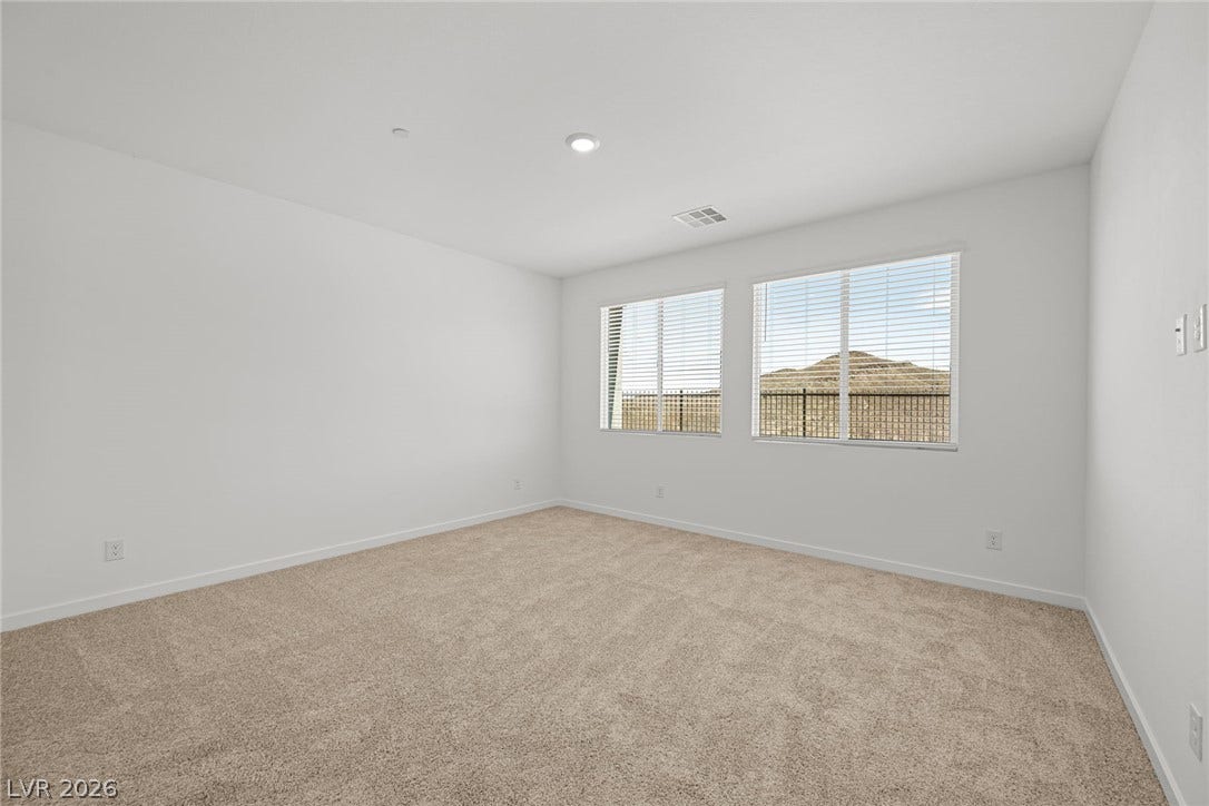 1670 Capri Falls Court, Henderson, NV 89011 Plush carpeting underfoot and wide windows looking out to the hills define this clean space.