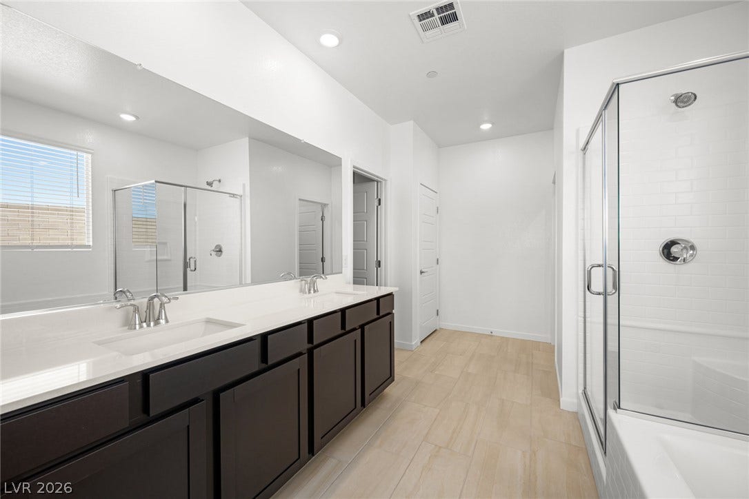 1670 Capri Falls Court, Henderson, NV 89011 Clean lines and a spacious dual vanity highlight this contemporary bathroom space.