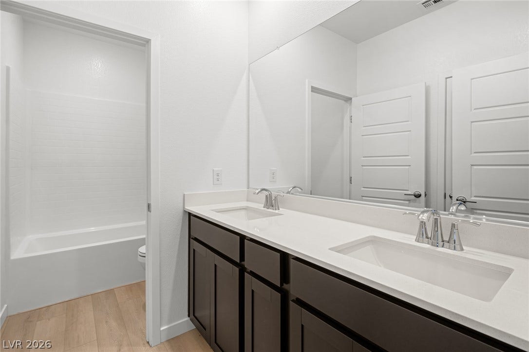 1670 Capri Falls Court, Henderson, NV 89011 Clean lines and a spacious dual vanity define this modern bathroom design.