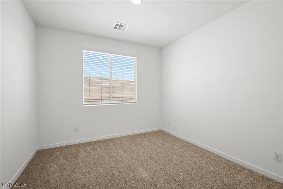 1670 Capri Falls Court, Henderson, NV 89011 Plush carpeting and a large window create a serene atmosphere in this versatile bedroom.