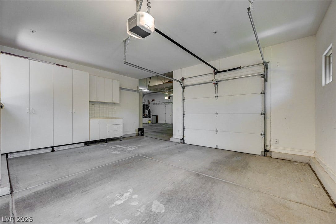 8 Starbrook Drive, Henderson, NV 89052 Ample built-in storage cabinets line the wall of this clean concrete floor garage.