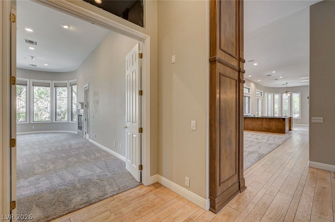 8 Starbrook Drive, Henderson, NV 89052 Gleaming hardwood floors guide the way into a carpeted living space with bay windows.
