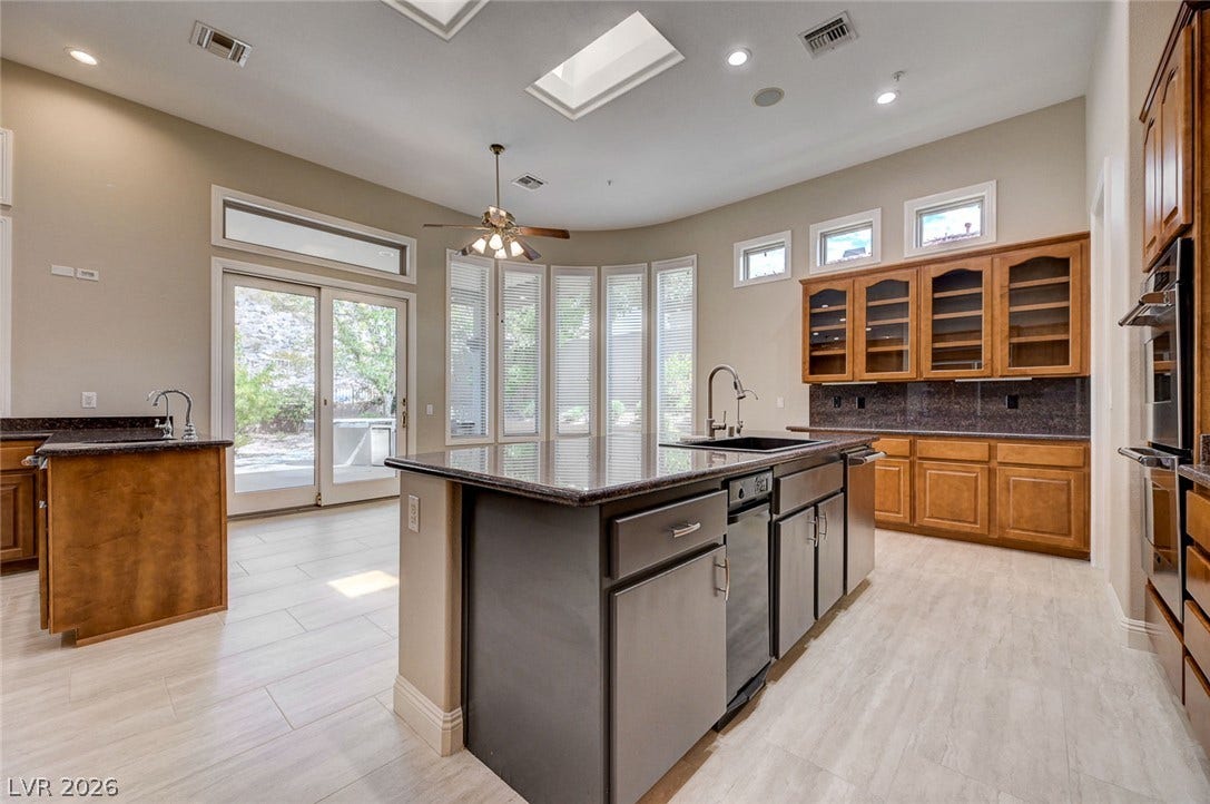 8 Starbrook Drive, Henderson, NV 89052 Natural light pours through dual skylights in this open kitchen with stone countertops.