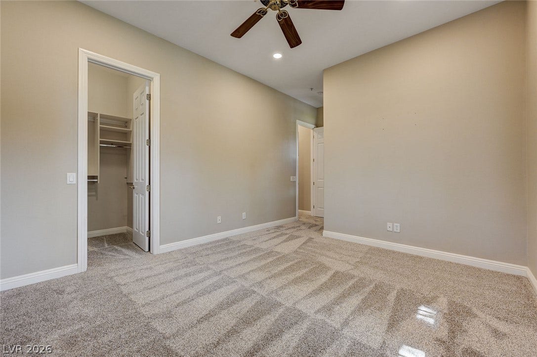 8 Starbrook Drive, Henderson, NV 89052 Plush carpeting and a walk-in closet highlight this comfortable bedroom space.