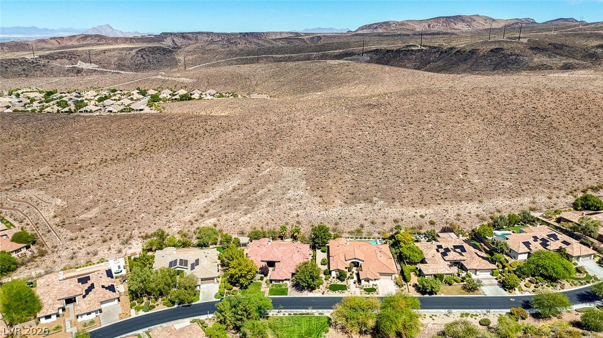 8 Starbrook Drive, Henderson, NV 89052 Rugged desert hills stretch endlessly behind a neat row of suburban homes.