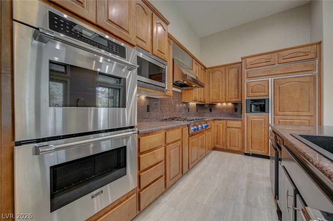 8 Starbrook Drive, Henderson, NV 89052 Gleaming stainless steel appliances complement the warm wood cabinetry in this expansive kitchen.